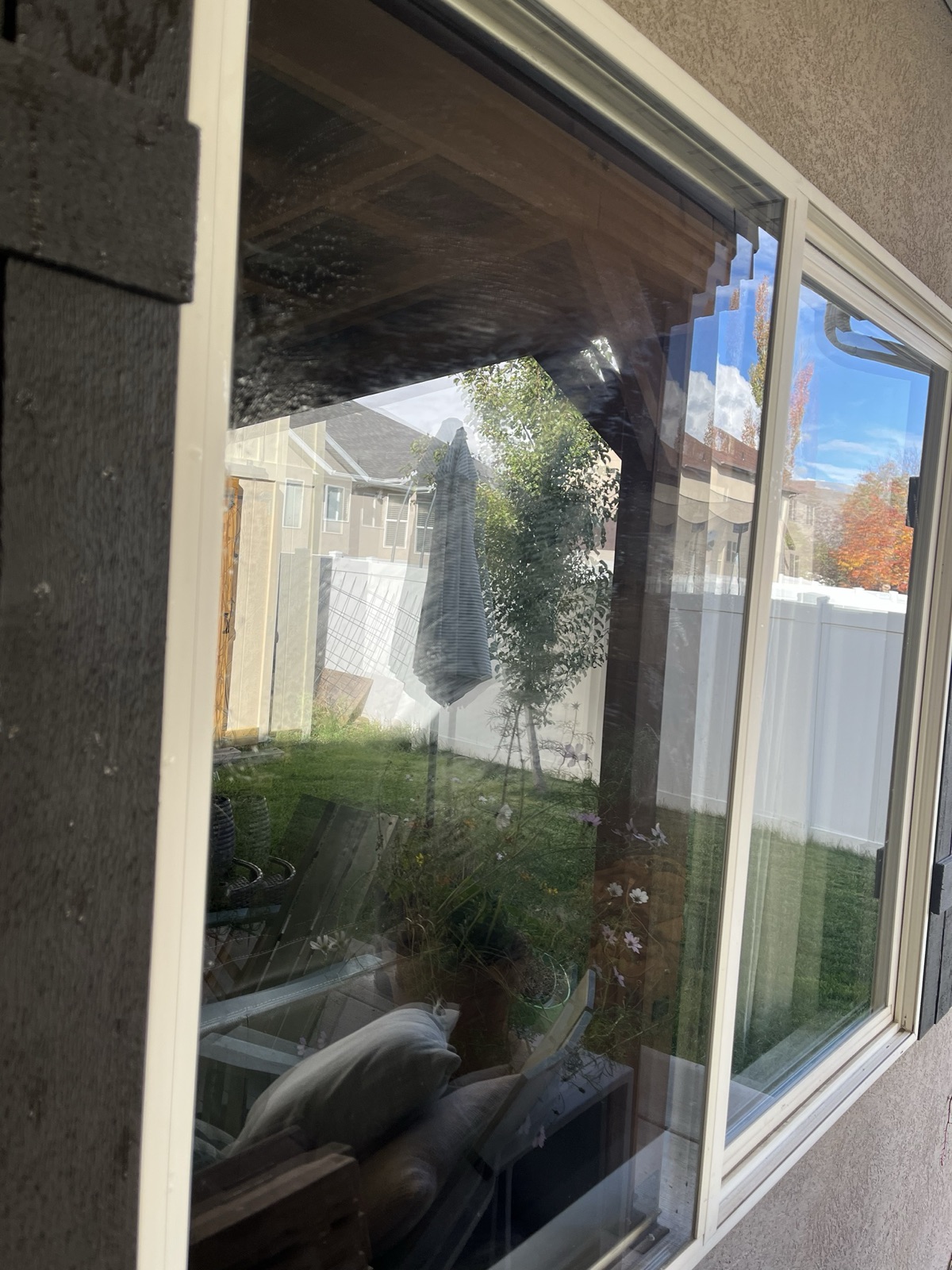Back-patio window covered in hard-water spots and streaks